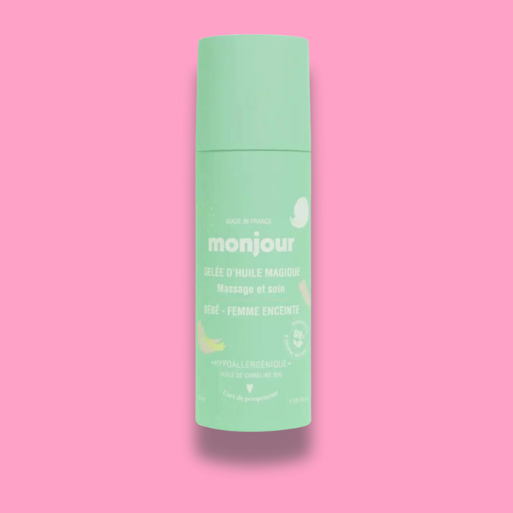 Huile de Massage Monjour, soin naturel pour bébé et femme enceinte, flacon sur fond rose.