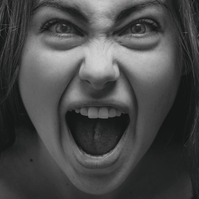 Femme en post-partum qui crie, illustrant la charge mentale et la détresse émotionnelle des jeunes mamans