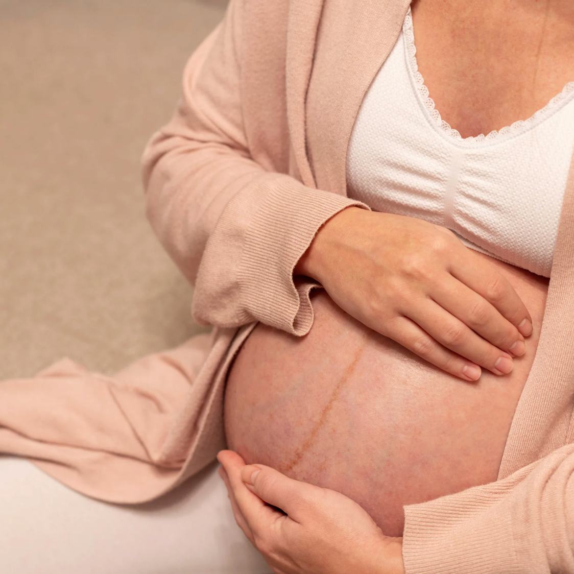 Compléments et soins maternité pour se préparer sereinement à l’accouchement, sur fond de salle de bain chic aux nuances chaudes et apaisantes.