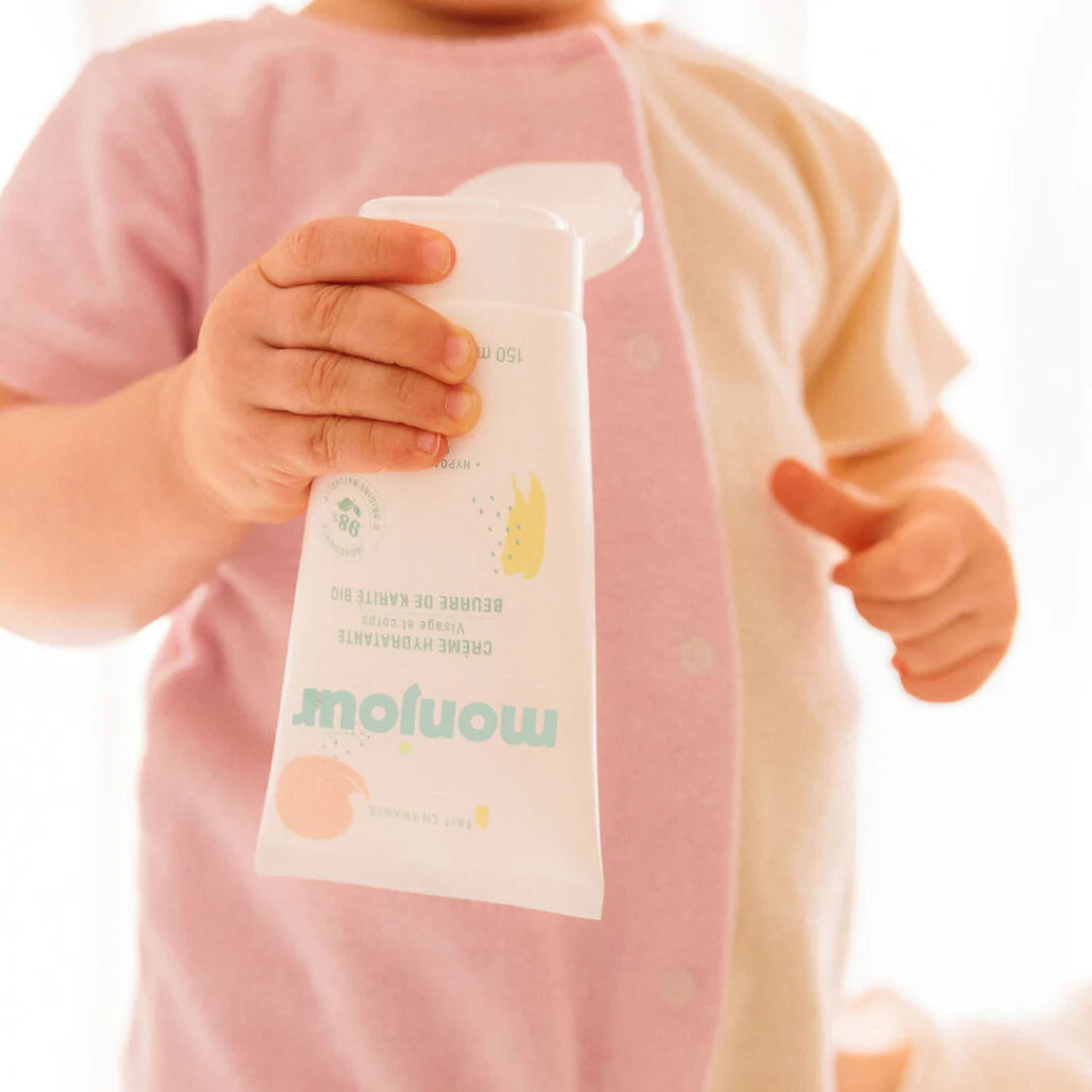 Enfant tenant un tube de crème hydratante Monjour, soin visage et corps naturel et hypoallergénique