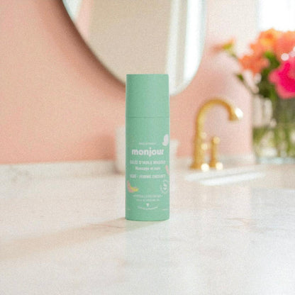 Gelée d’Huile de Massage Monjour posée sur une table en marbre, soin nourrissant et apaisant pour bébé et maman